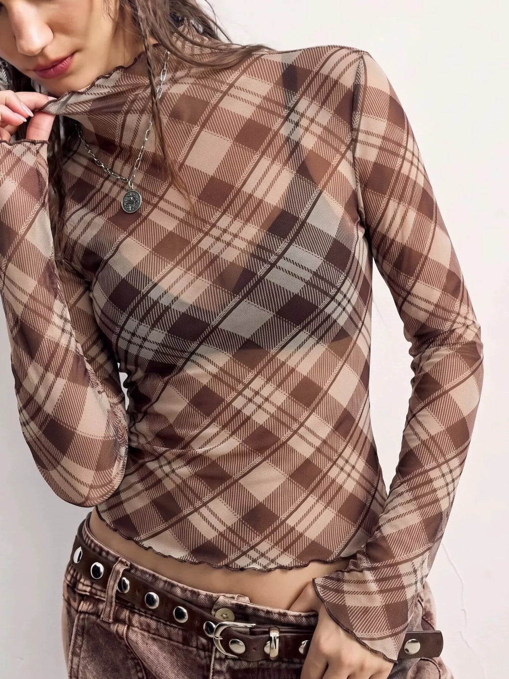 Sheer mesh plaid mock neck long sleeve T-shirt from Trendsi, featuring a stylish see-through fabric with a classic plaid pattern.