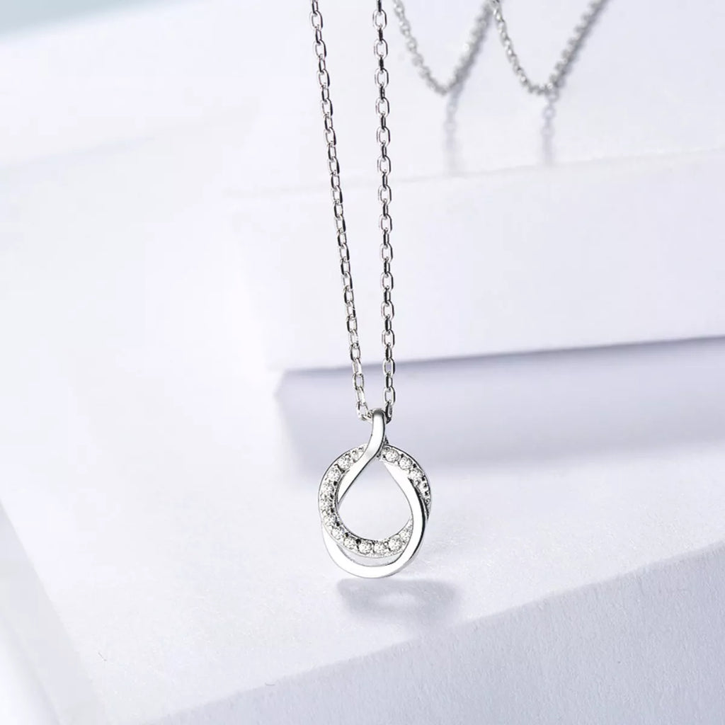 Sterling silver zircon pendant necklace with a delicate chain, featuring a sparkling zircon stone in a stylish design.