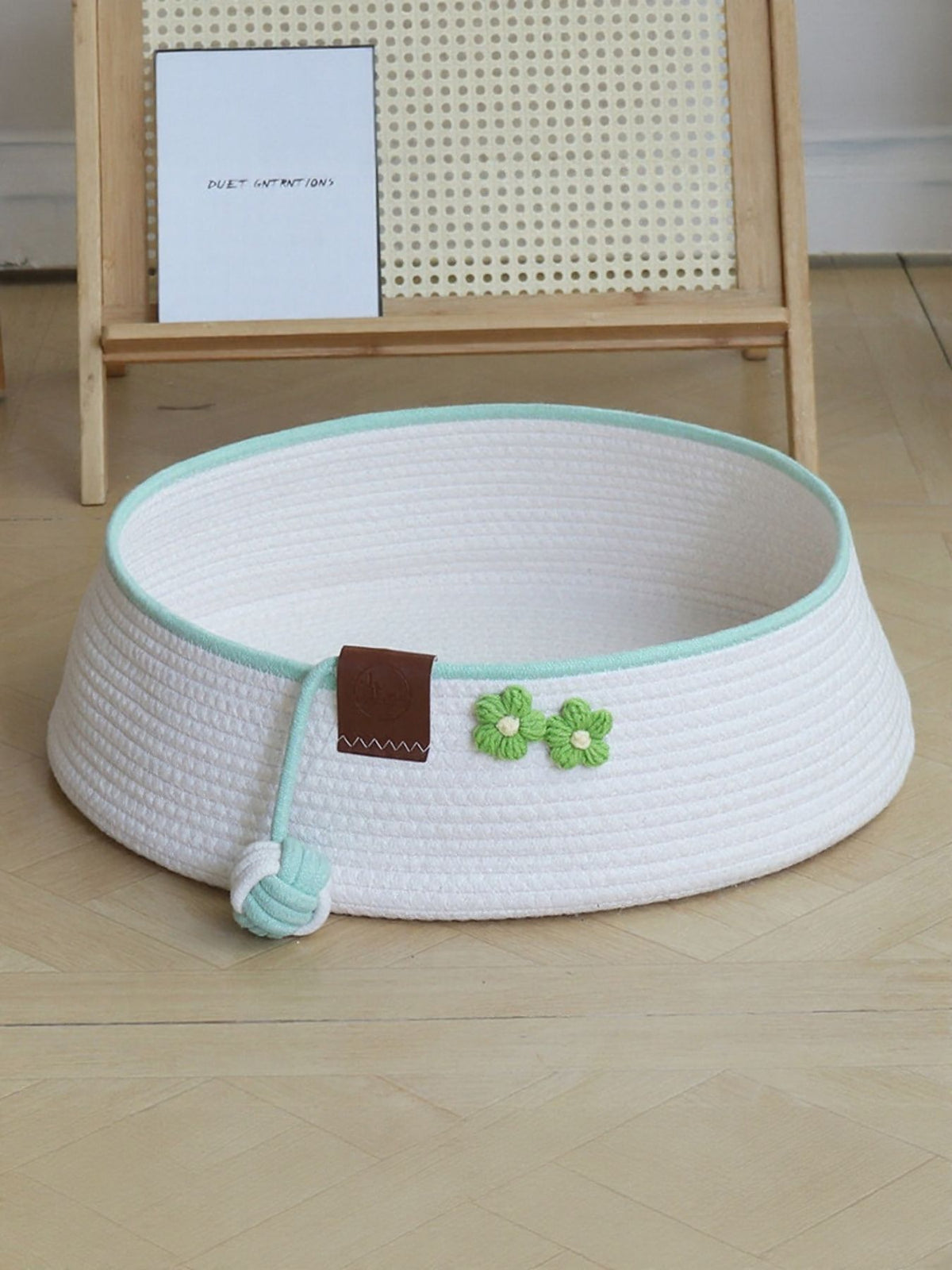Woven pet nest with soft interior and attached toy ball, cozy resting spot for small pets by Trendsi