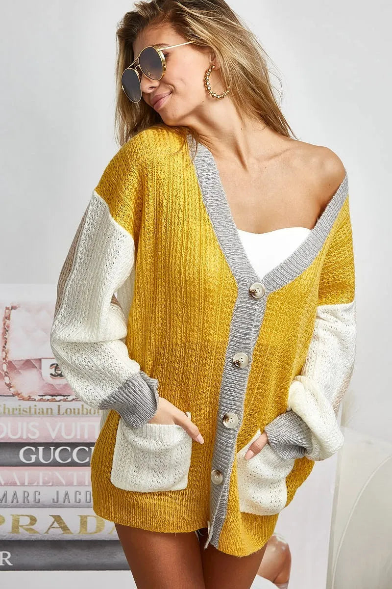 Color block BiBi sweater cardigan with button closure, trendy knitwear by Trendsi featuring bold color blocking and cozy design.