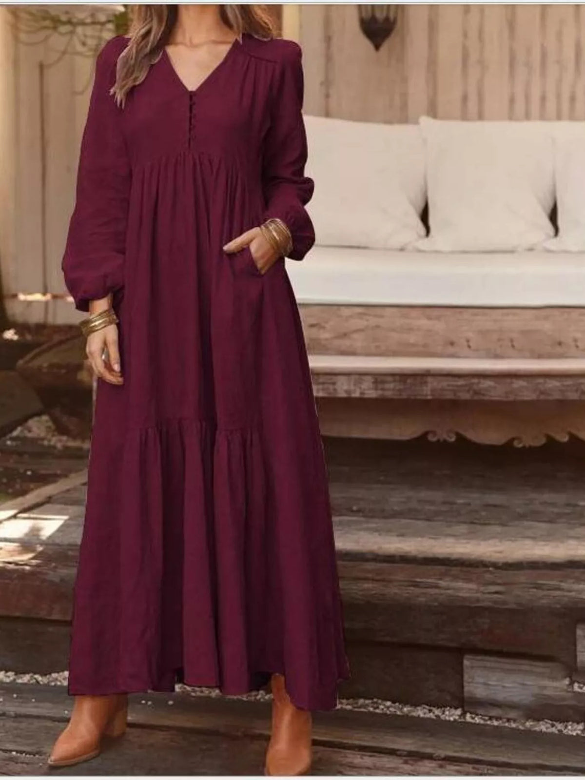 Full size V-neck long sleeve tiered maxi dress with pockets by Trendsi, featuring a flowing fabric and comfortable fit.