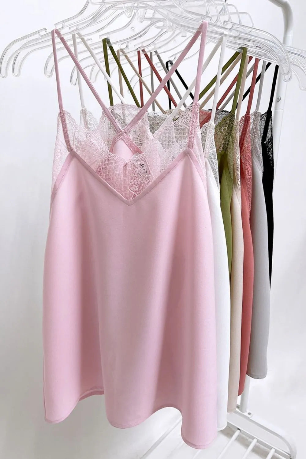 BiBi Lace Cami Solid Tank Top by Trendsi featuring delicate lace trim and a fitted sleeveless design in soft fabric.