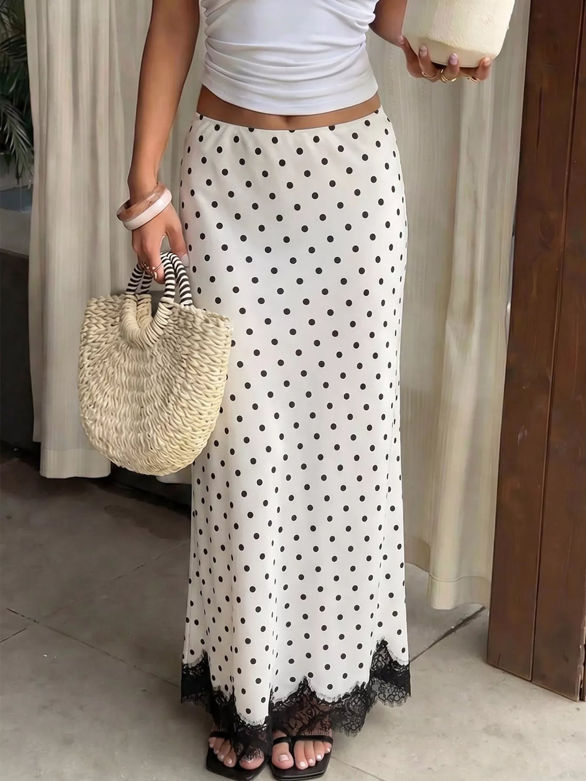 Polka dot high-waisted maxi skirt with lace hem from Trendsi, flowing fabric and stylish design, perfect for summer wear.