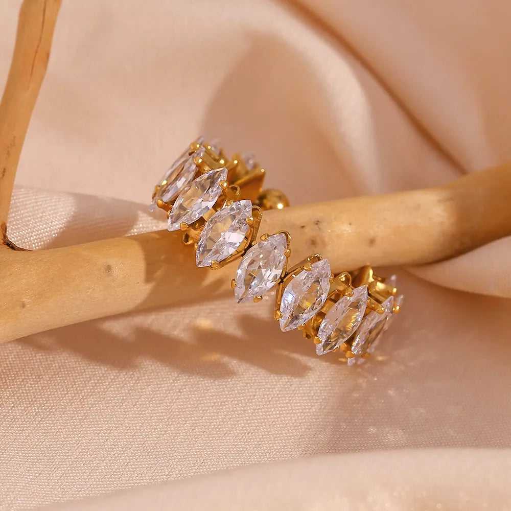 18K gold-plated zircon bracelet and ring jewelry set featuring sparkling zircon stones on elegant gold-toned jewelry.