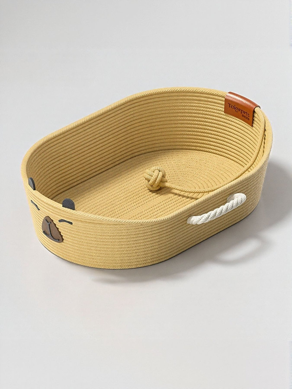 Woven Rope Oval Pet Bed by Trendsi with soft cushion inside, perfect for small dogs or cats, in natural woven design.