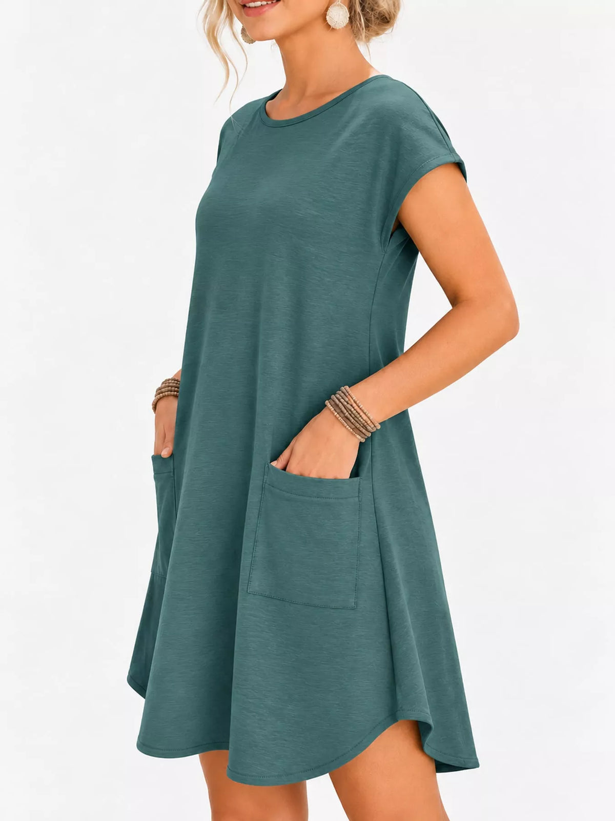 Loose fit T-shirt dress with pockets by Trendsi, featuring a casual style and comfortable fabric, shown in a relaxed fit.