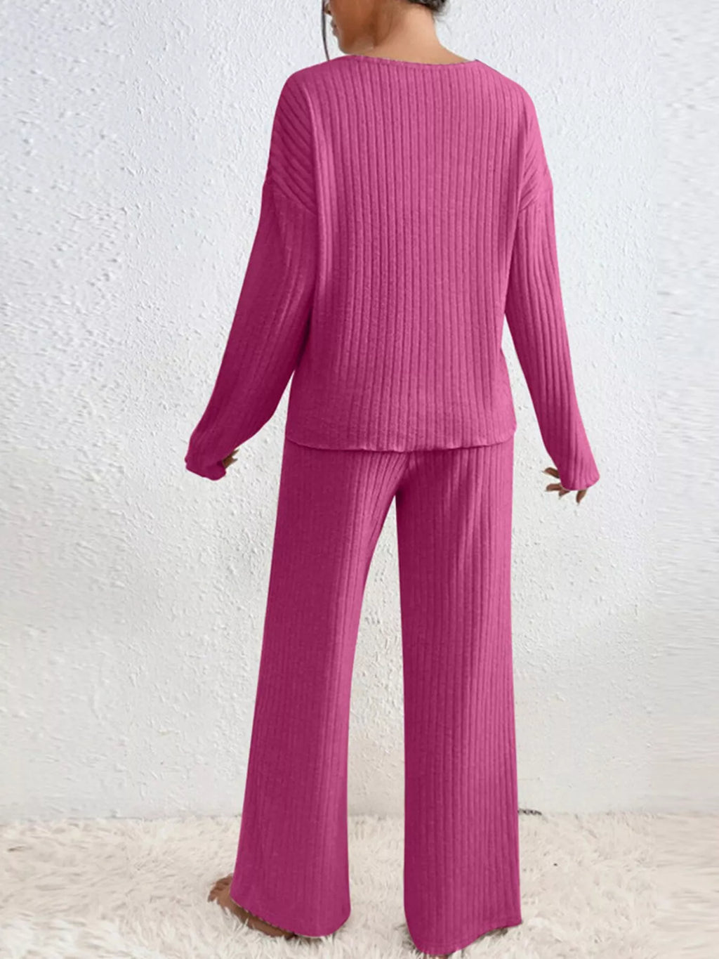 Ribbed knit V-neck top and pants set by Trendsi, featuring a cozy, fitted design with vertical ribbing in soft fabric.