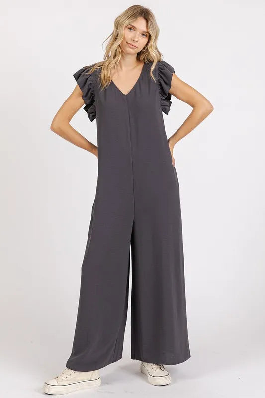 Trendsi Mittoshop v-neck ruffled cap sleeve wide-leg jumpsuit displayed on a hanger with detailed ruffle and flowy fabric