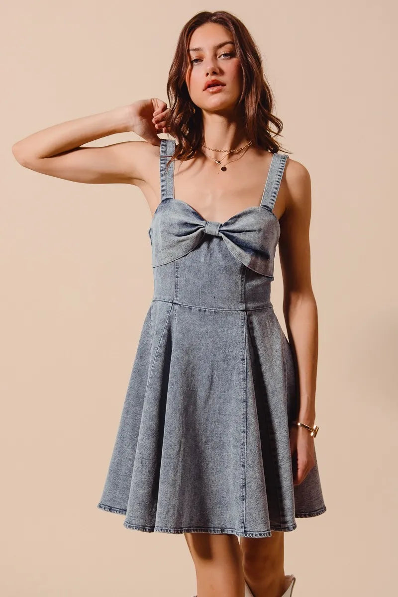 Mineral washed bow ribbon denim flare dress by Trendsi featuring a classic silhouette and casual style.