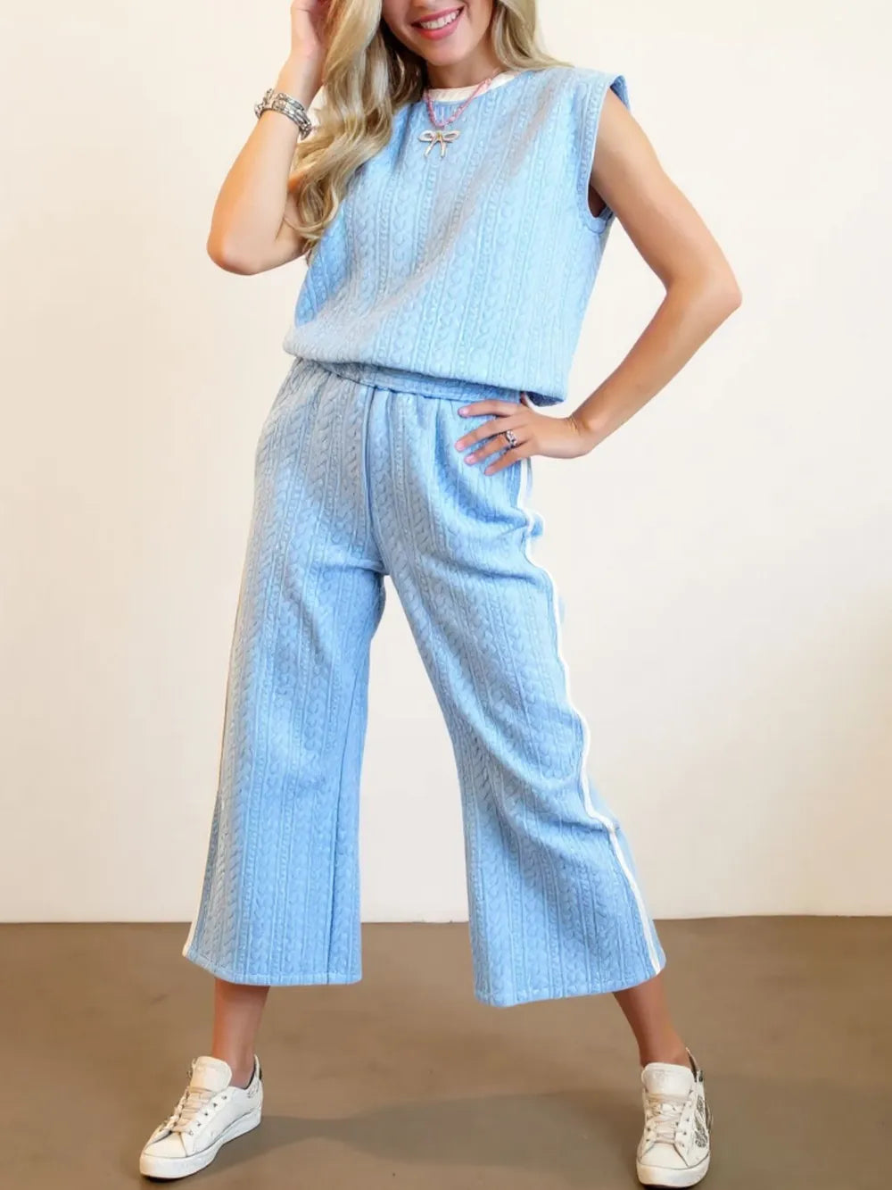 Oh full size texture contrast trim round neck top and pants set by Trendsi, featuring a stylish textured fabric and color contrast details.