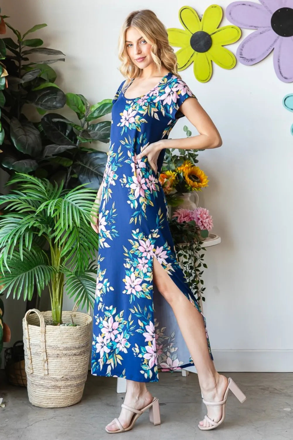 Heimish full size floral short sleeve slit dress with a relaxed fit, featuring a vibrant floral pattern and a modest slit on the side.