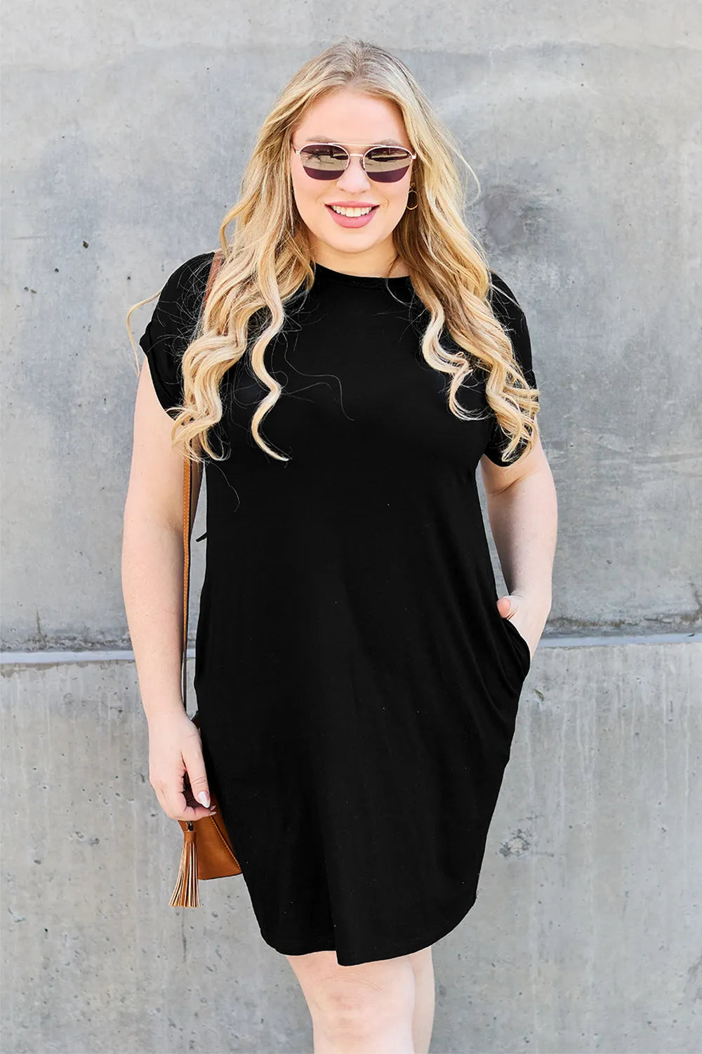 Trendsi Basic Bae bamboo full-size round neck short sleeve dress with pockets, showing a comfortable, natural-colored dress on a hanger.