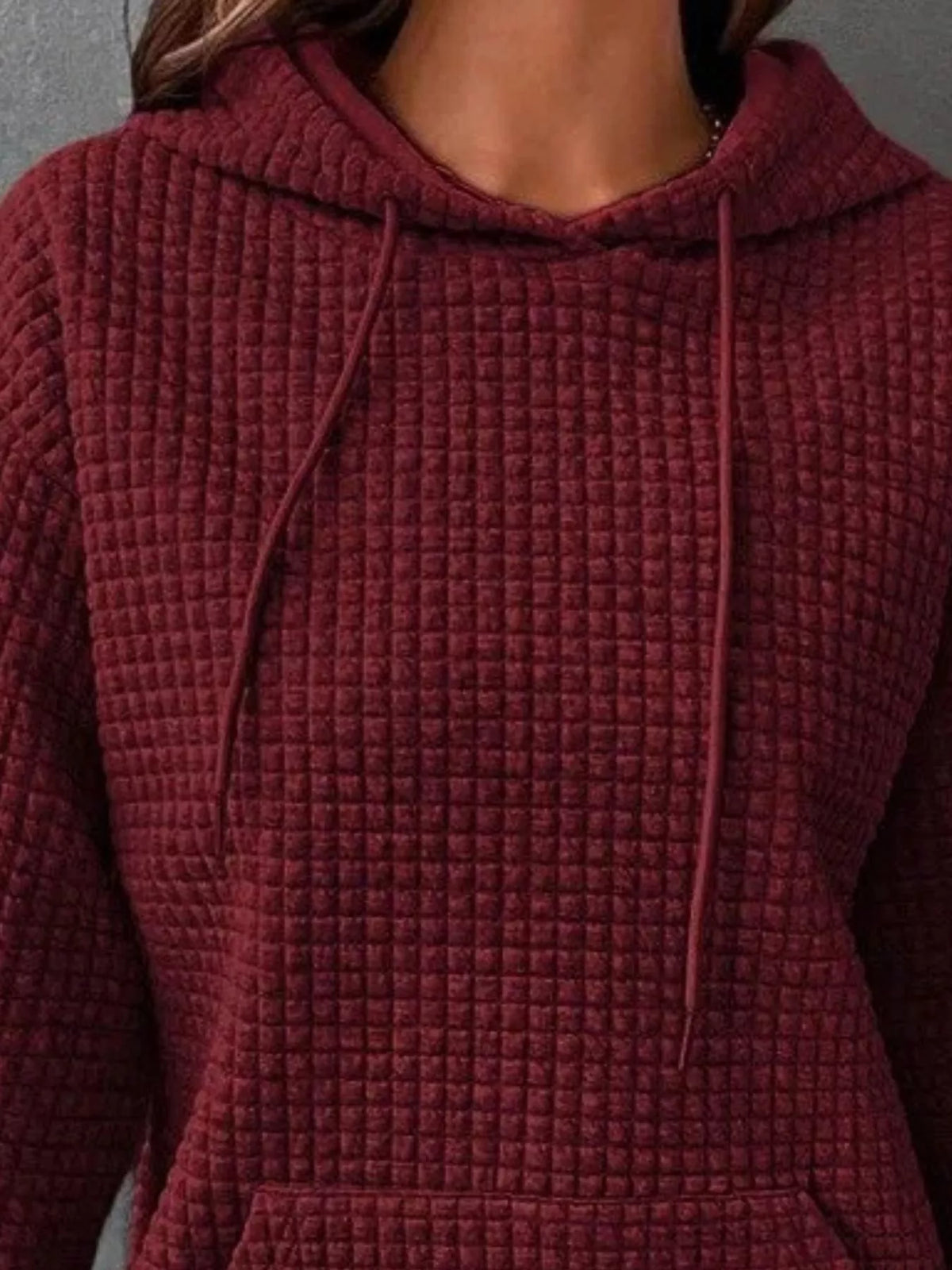Plus size textured kangaroo pocket hoodie with full size fit, featuring a cozy hood and long sleeves, by Trendsi.