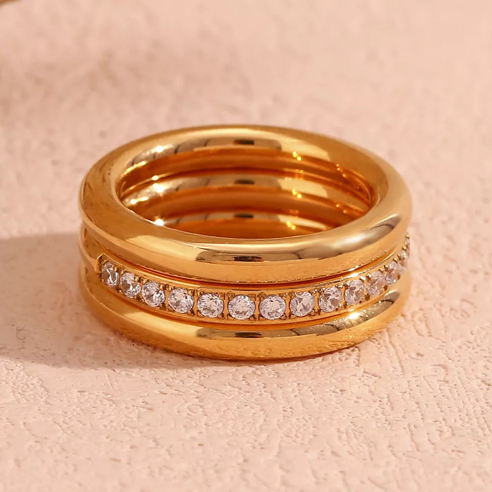 Set of three stainless steel zircon rings featuring sleek designs, perfect for stacking or everyday wear.