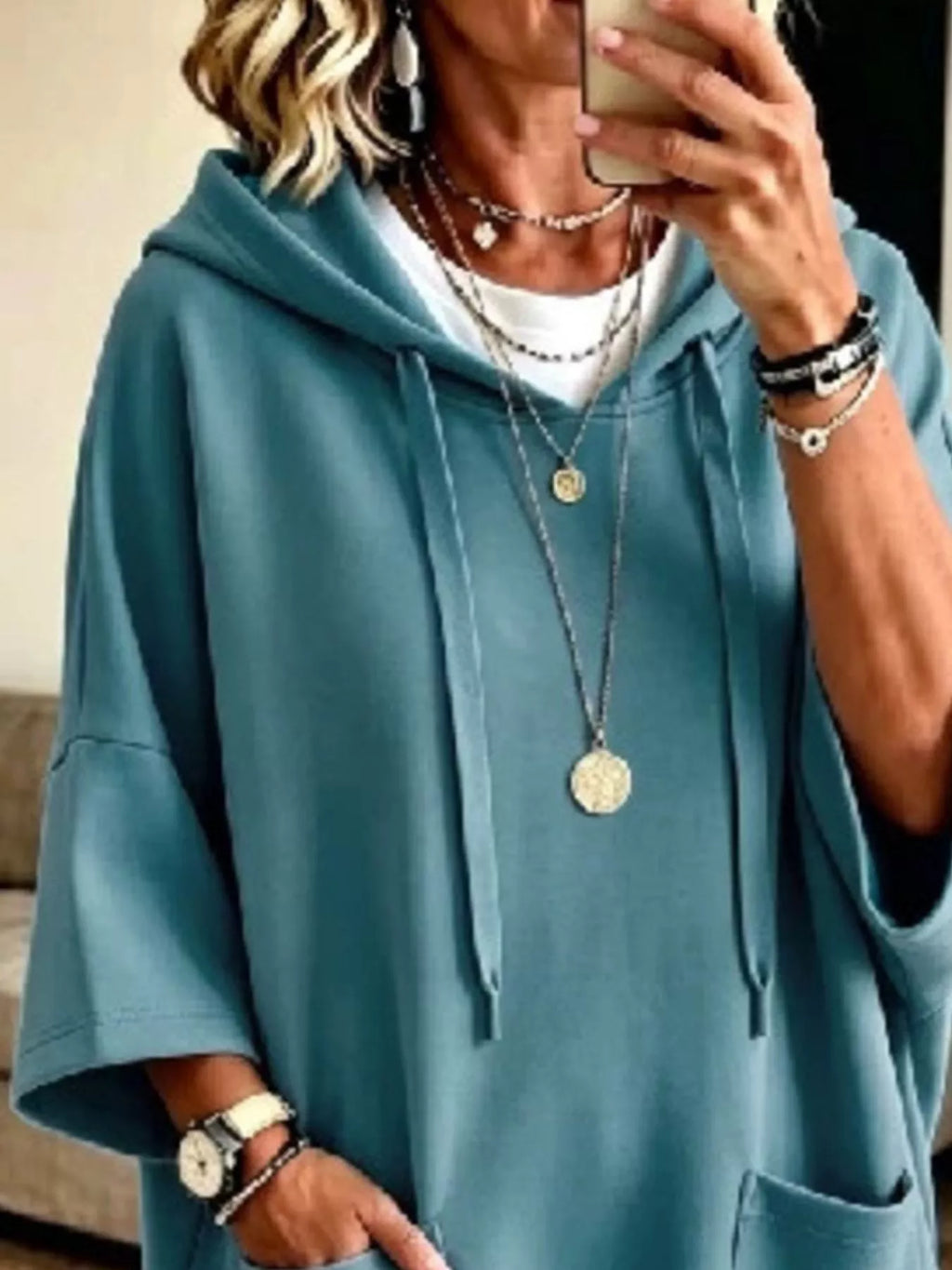 Plus size oversized hoodie with drawstring hood, front pockets, and a relaxed fit from Trendsi, shown in a full view.