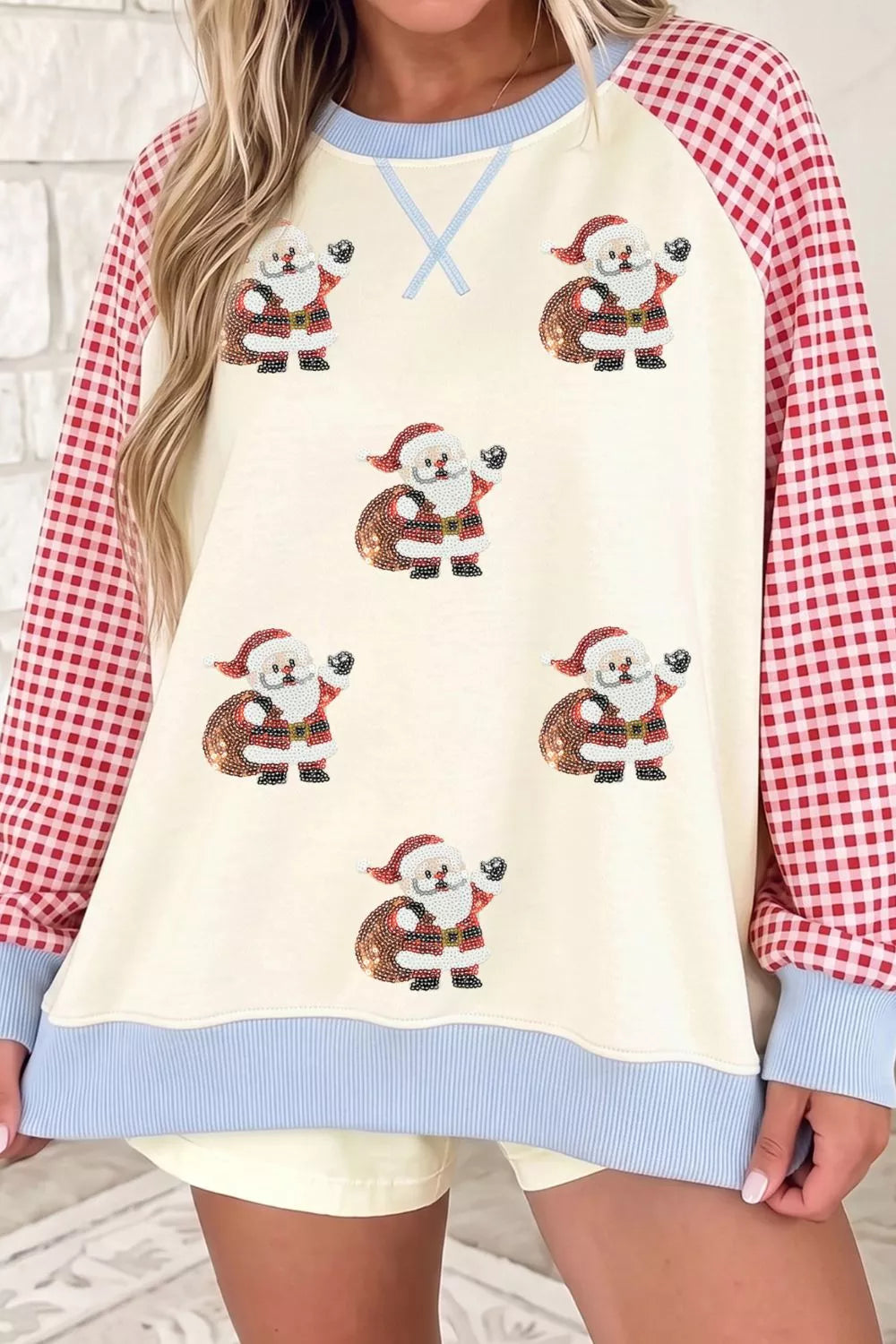 Beige Christmas sweatshirt with sequin Santa and plaid sleeves