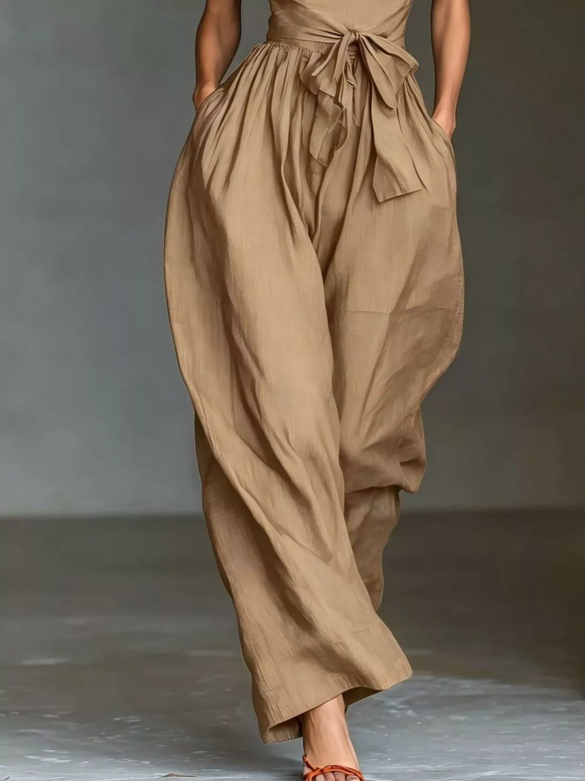 Halter neck wide-leg jumpsuit with waist-tie from Trendsi, featuring a stylish and flowy silhouette in the image.