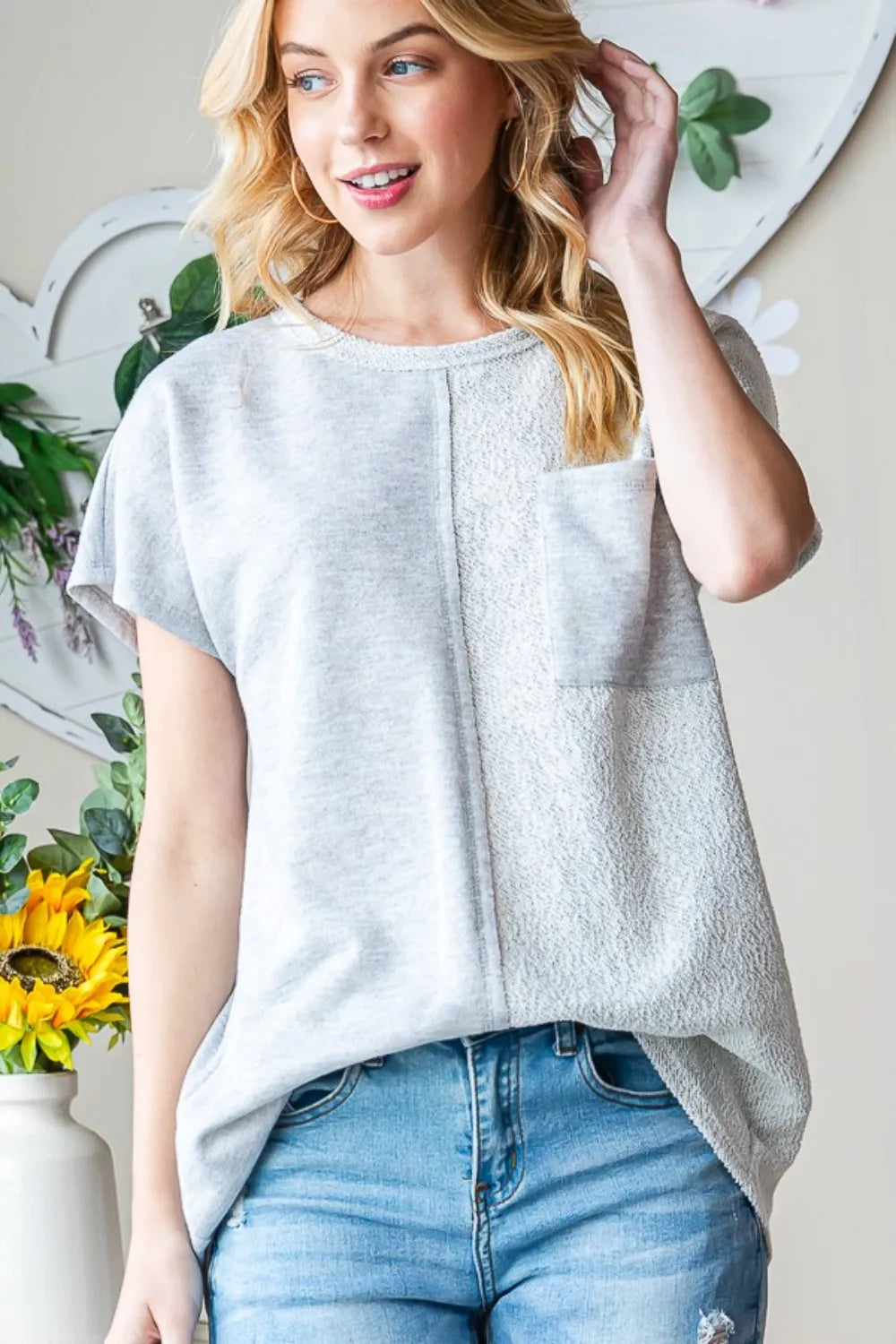 Heimish full-size pocketed round neck short sleeve T-shirt by Trendsi, featuring a classic fit and casual style in soft fabric.
