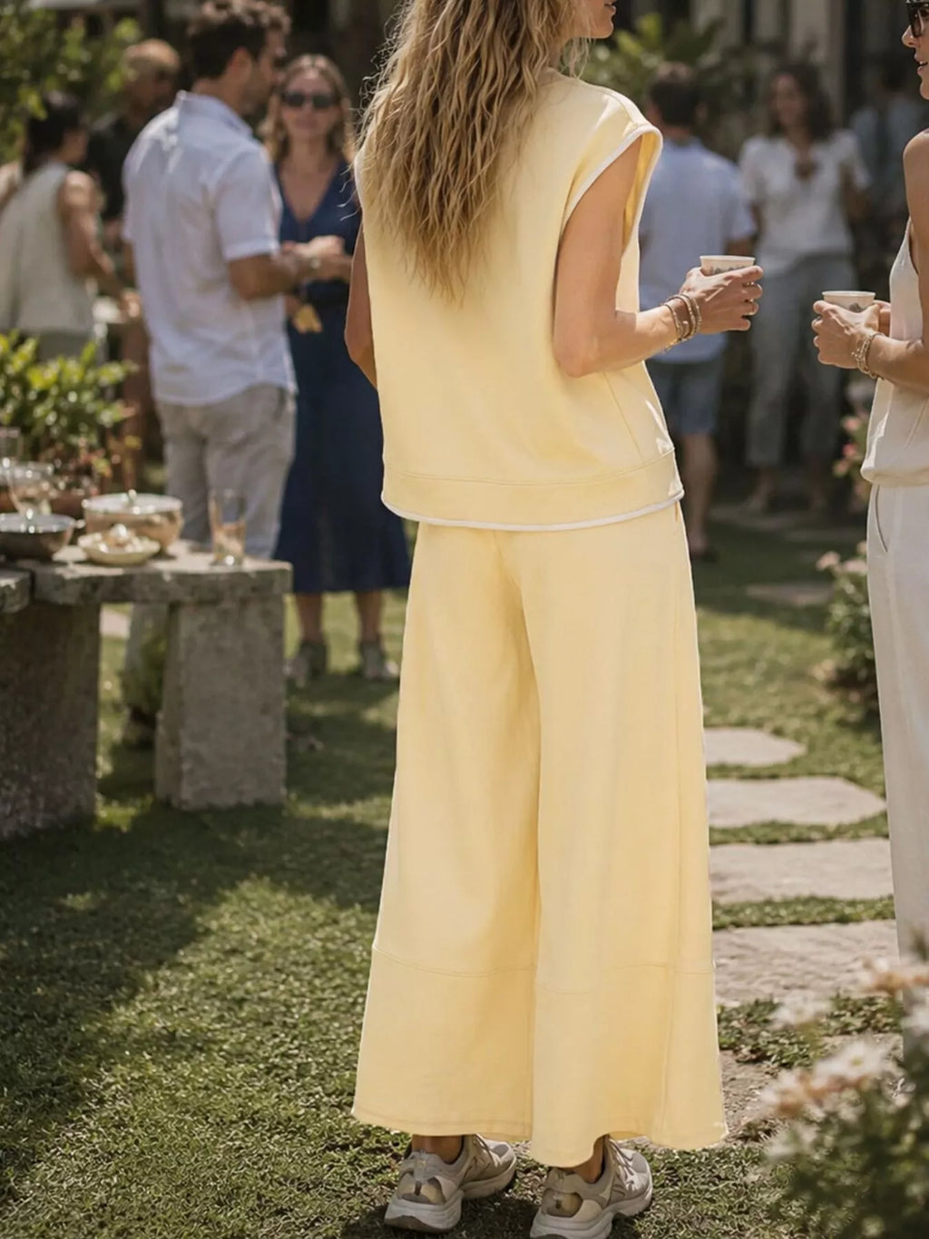 Trendsi sleeveless crew neck top and wide-leg cropped pants set, featuring a stylish, casual outfit with a relaxed fit.