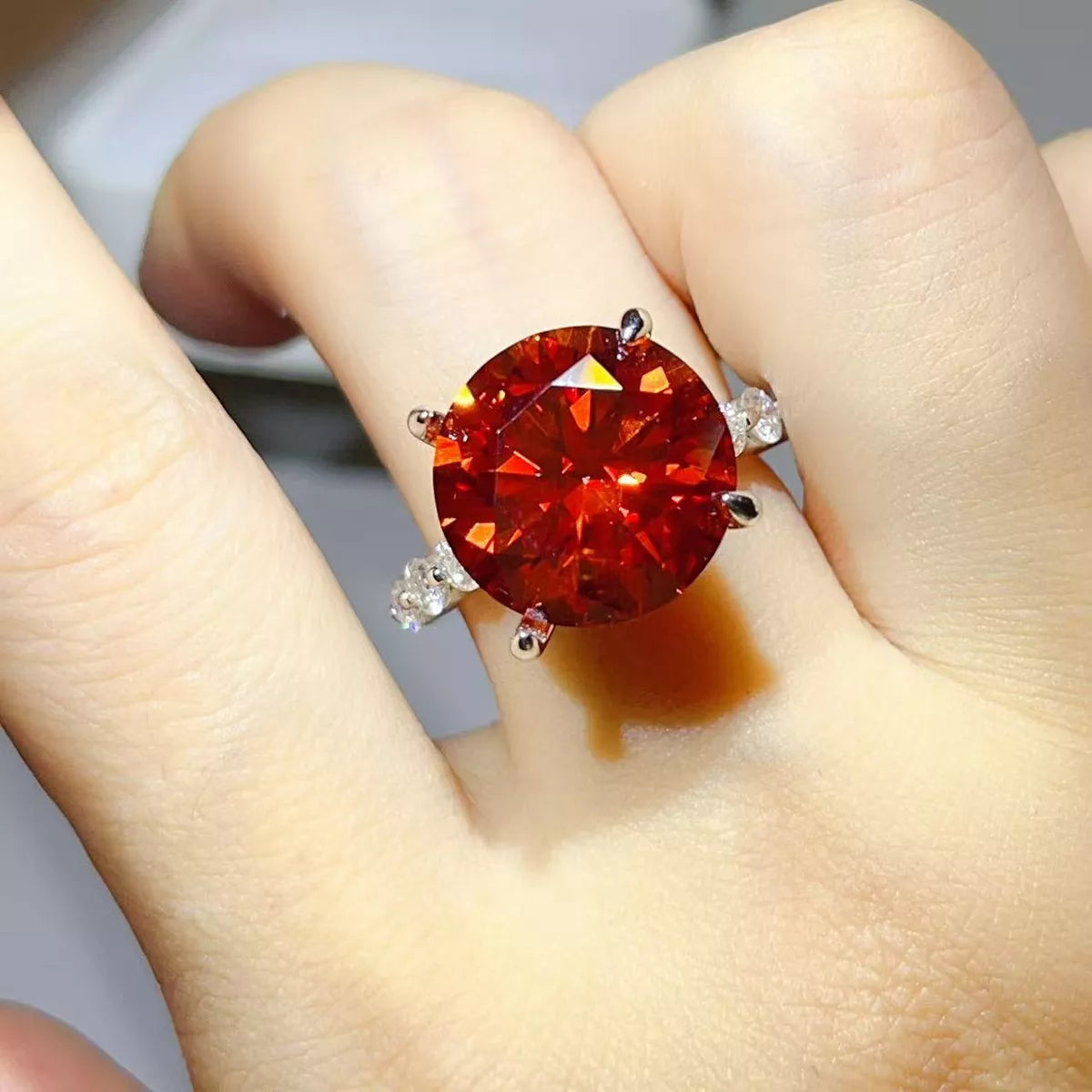 Sterling silver ring with a 10-carat moissanite gemstone, featuring a sparkling 5D cut and intricate band design.