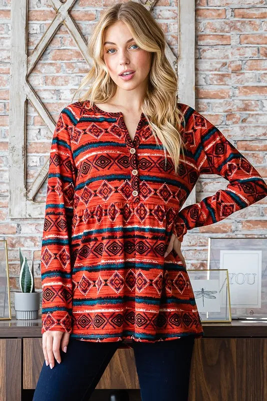 Heimish long sleeve babydoll top with geometric button details, showcasing a flowy fabric and feminine silhouette.