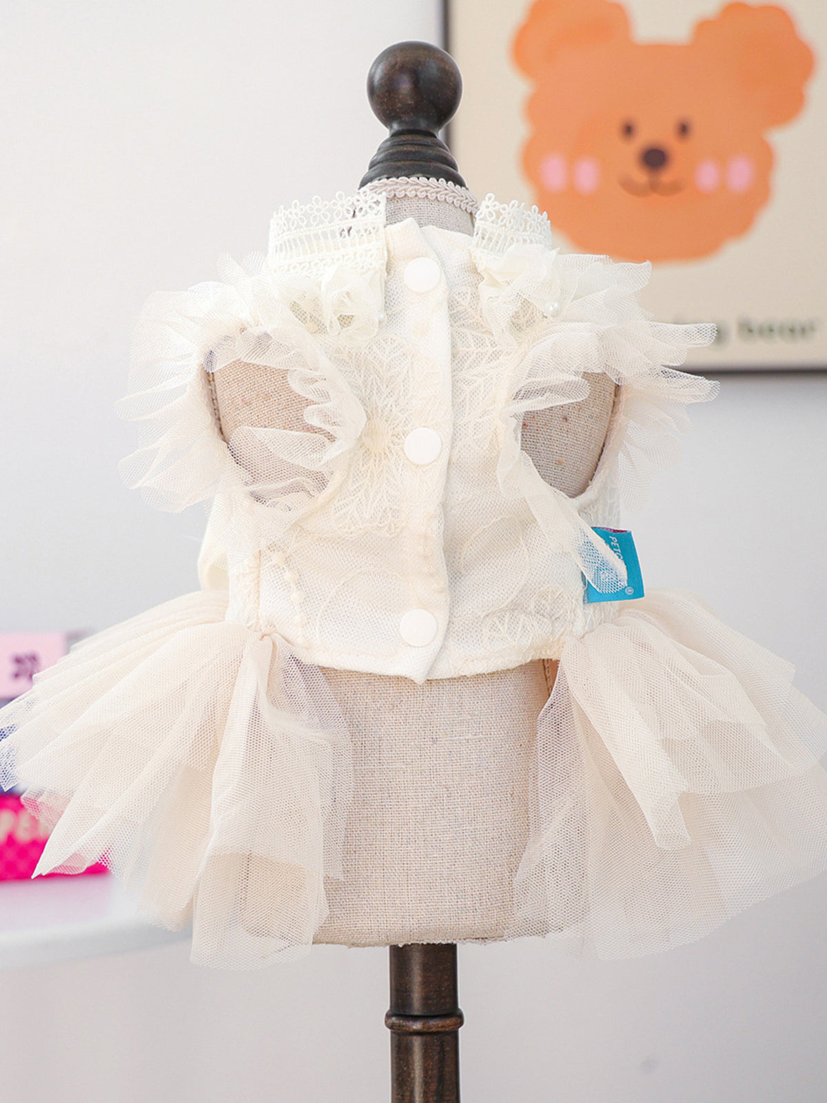 Pet dress with tulle ruffles and bow detail, designed for small dogs, featuring a charming and elegant style.