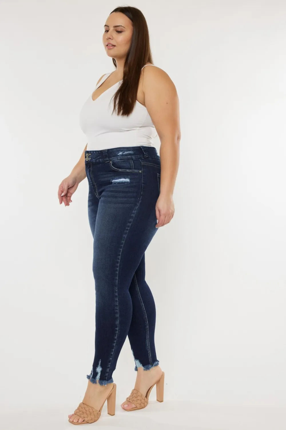 Kancan full-size high waist jeans featuring raw hem and whisker details, styled with casual top and accessories.