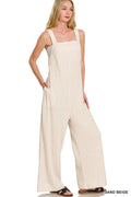 Light beige Zenana Knit Waffle Wide Leg Overalls with adjustable straps and front pockets, styled on a model.