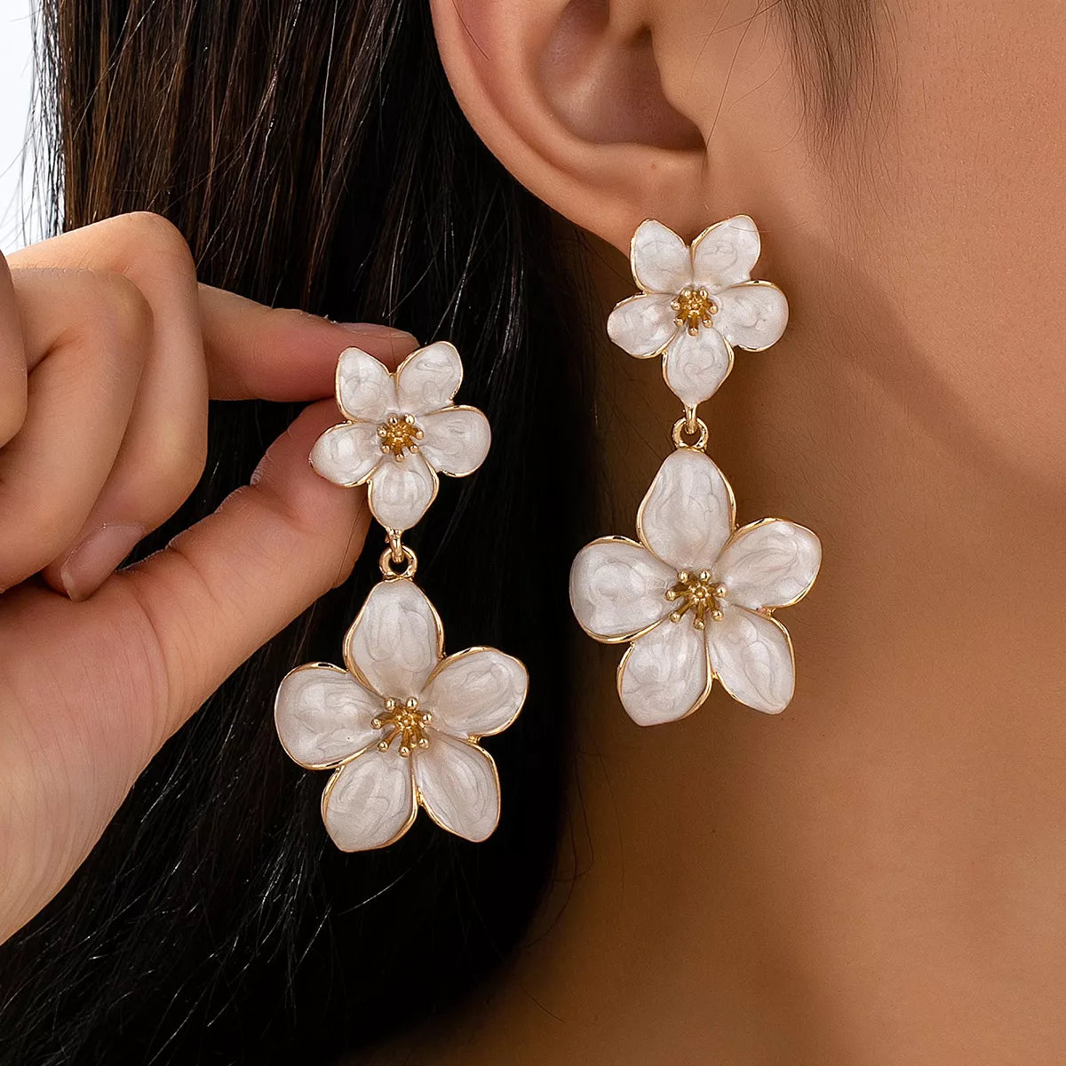 Flower dangle earrings from Trendsi featuring intricate floral design and delicate hanging elements.