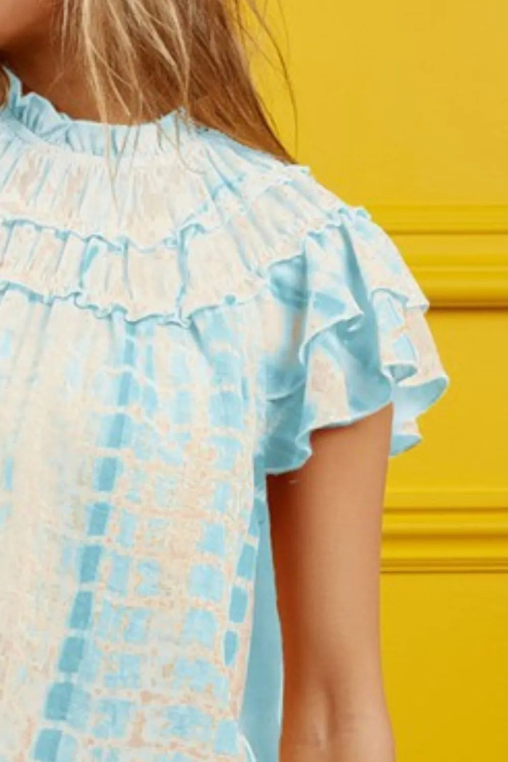 Colorful tie-dye BiBi tiered ruffle neck top by Trendsi, featuring a stylish ruffled neckline and flowy silhouette.