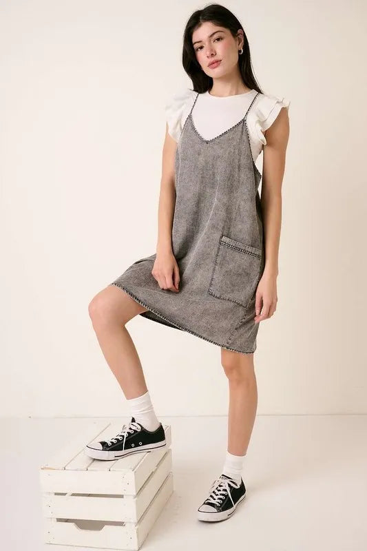 Washed patch pocket mini denim cami dress by Mittoshop, stylish and casual, featuring a sleeveless design and front patch pockets.