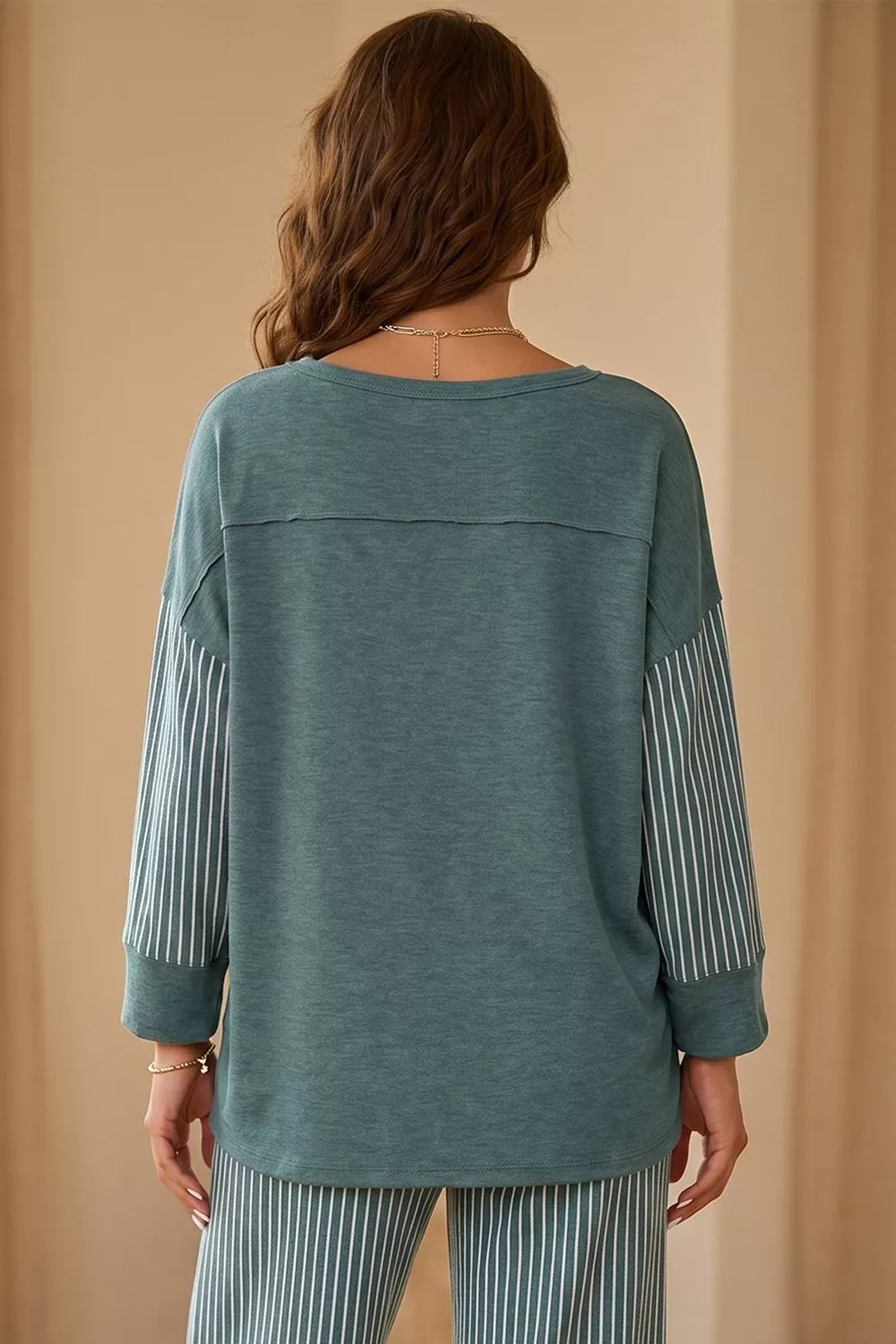 Raw seam patchwork long sleeve top and casual pants 2-piece set by Trendsi, featuring a relaxed fit and pocket details.