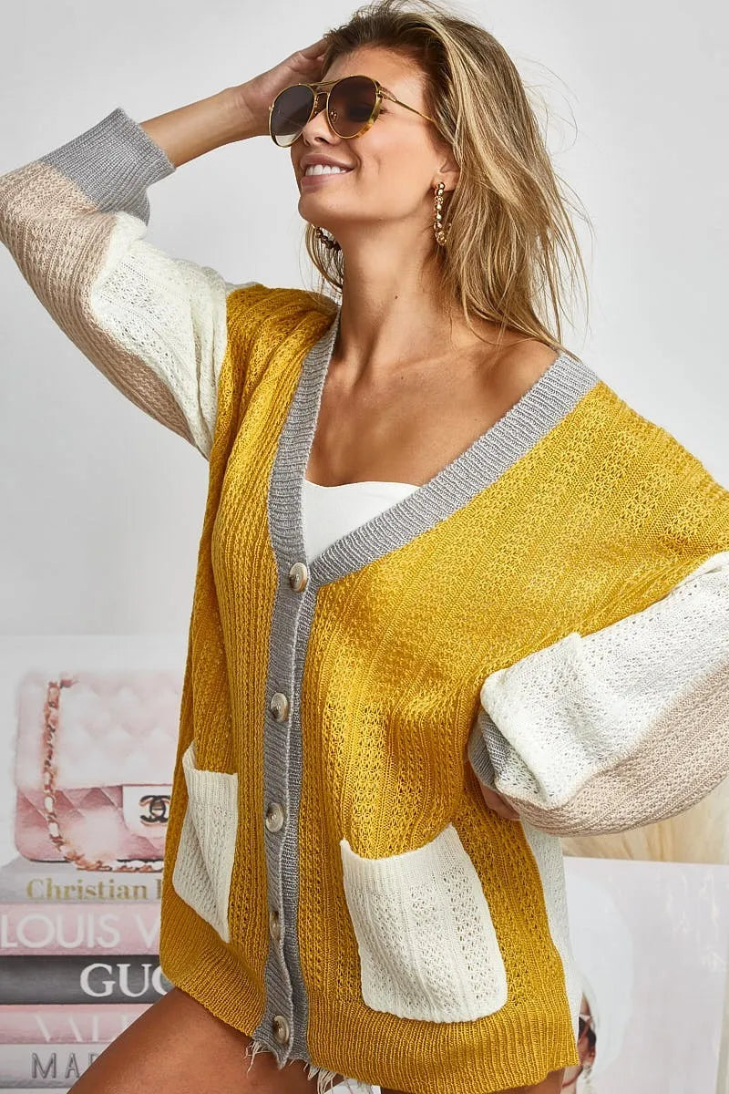 Color block sweater cardigan with button closure by Trendsi, featuring a stylish design and cozy knit fabric.