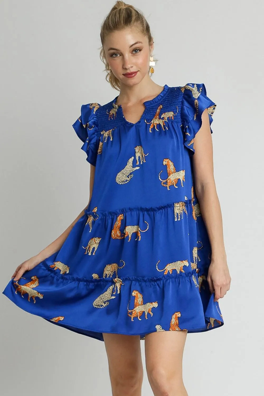 Plus size Umgee cheetah print mini dress with notched neckline, ruffle details, layered cap sleeves, and a stylish, casual fit.