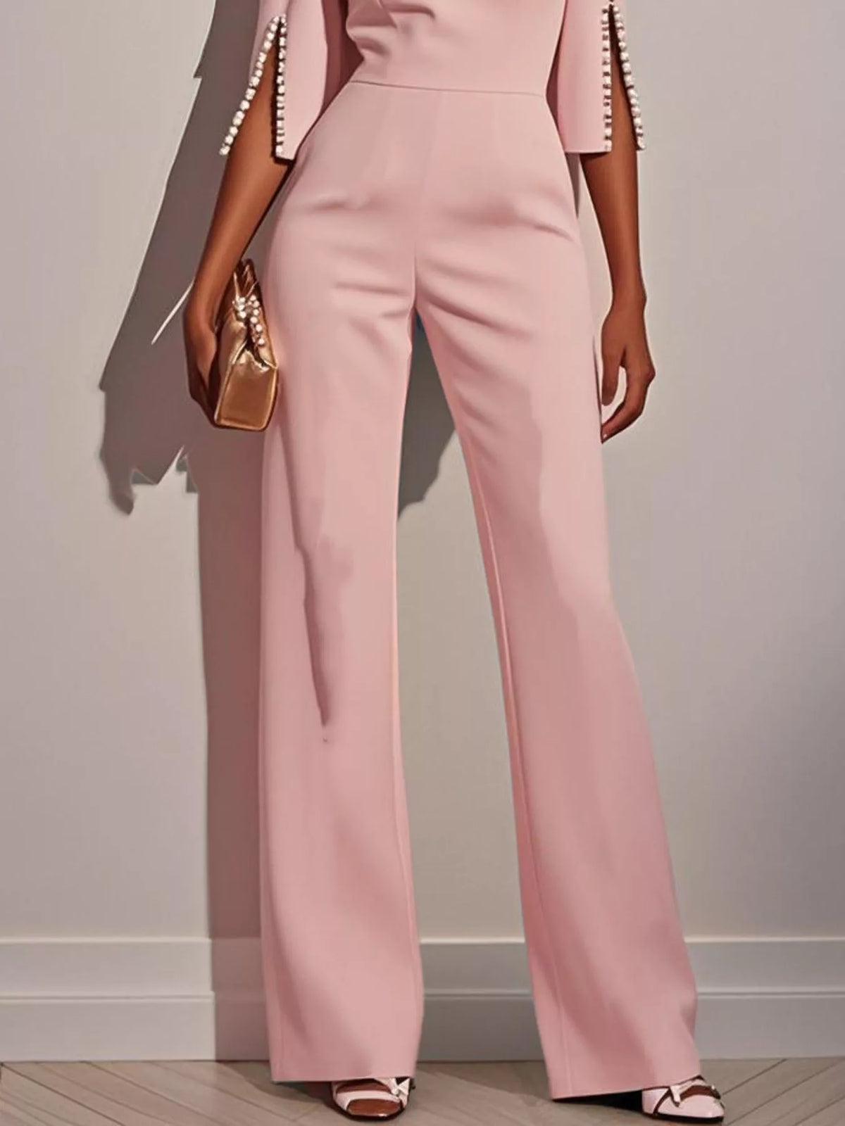 Wide-leg jumpsuit with slit sleeves by Trendsi, featuring flowing fabric and stylish cut-out sleeves in a modern design.