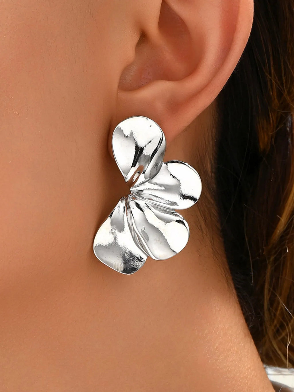 Stainless steel flower earrings with intricate petal design, stylish jewelry accessory, shiny silver finish, trendy and lightweight.
