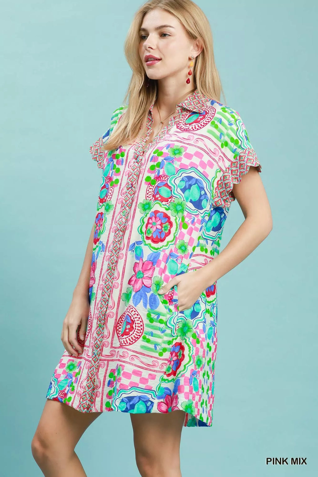 Umgee Mediterranean print dress with contrast printed trim, featuring a flowy silhouette and vibrant pattern, ideal for casual wear.