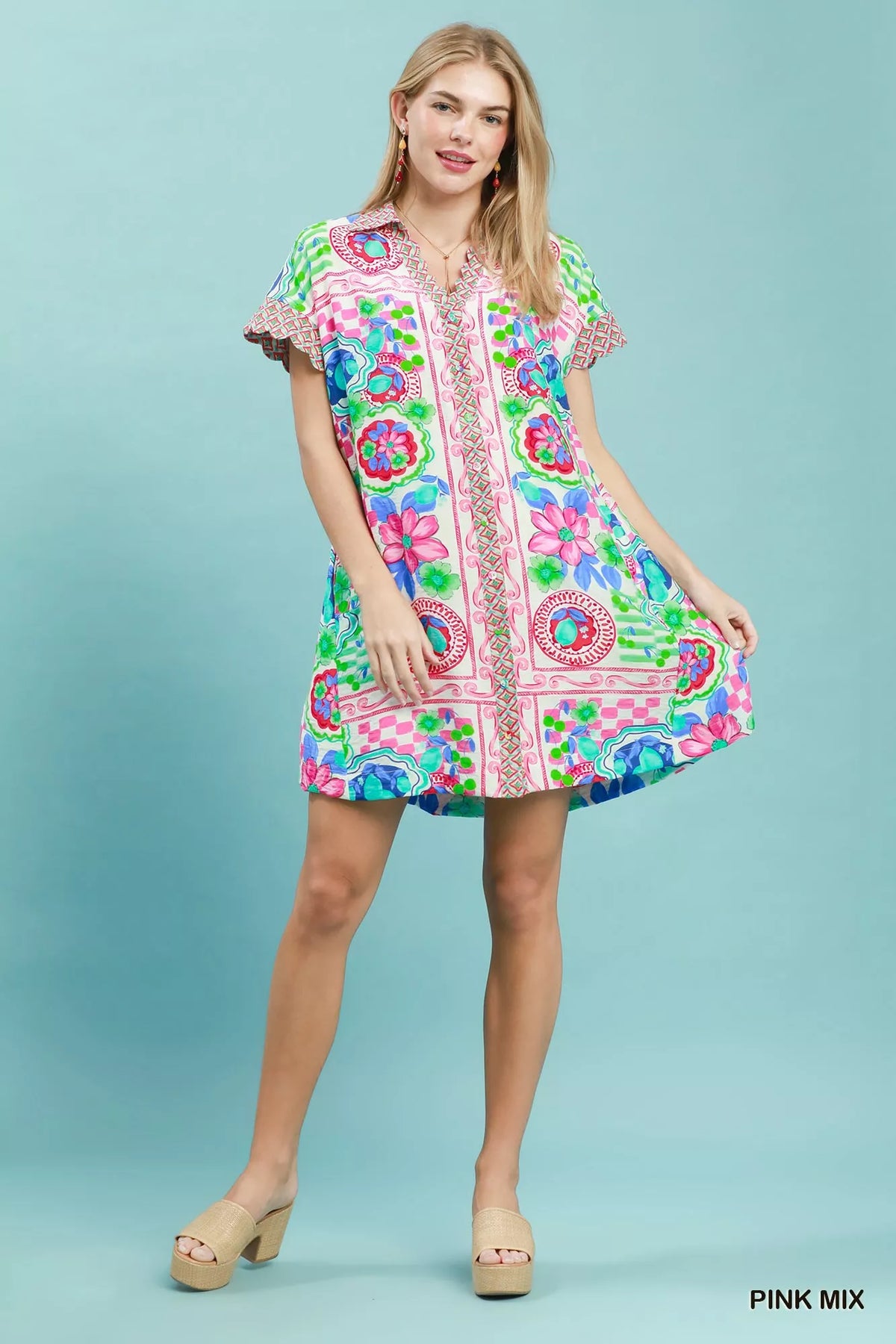Umgee Mediterranean print dress with contrast printed trim, featuring a flowy silhouette and vibrant pattern, perfect for casual wear.