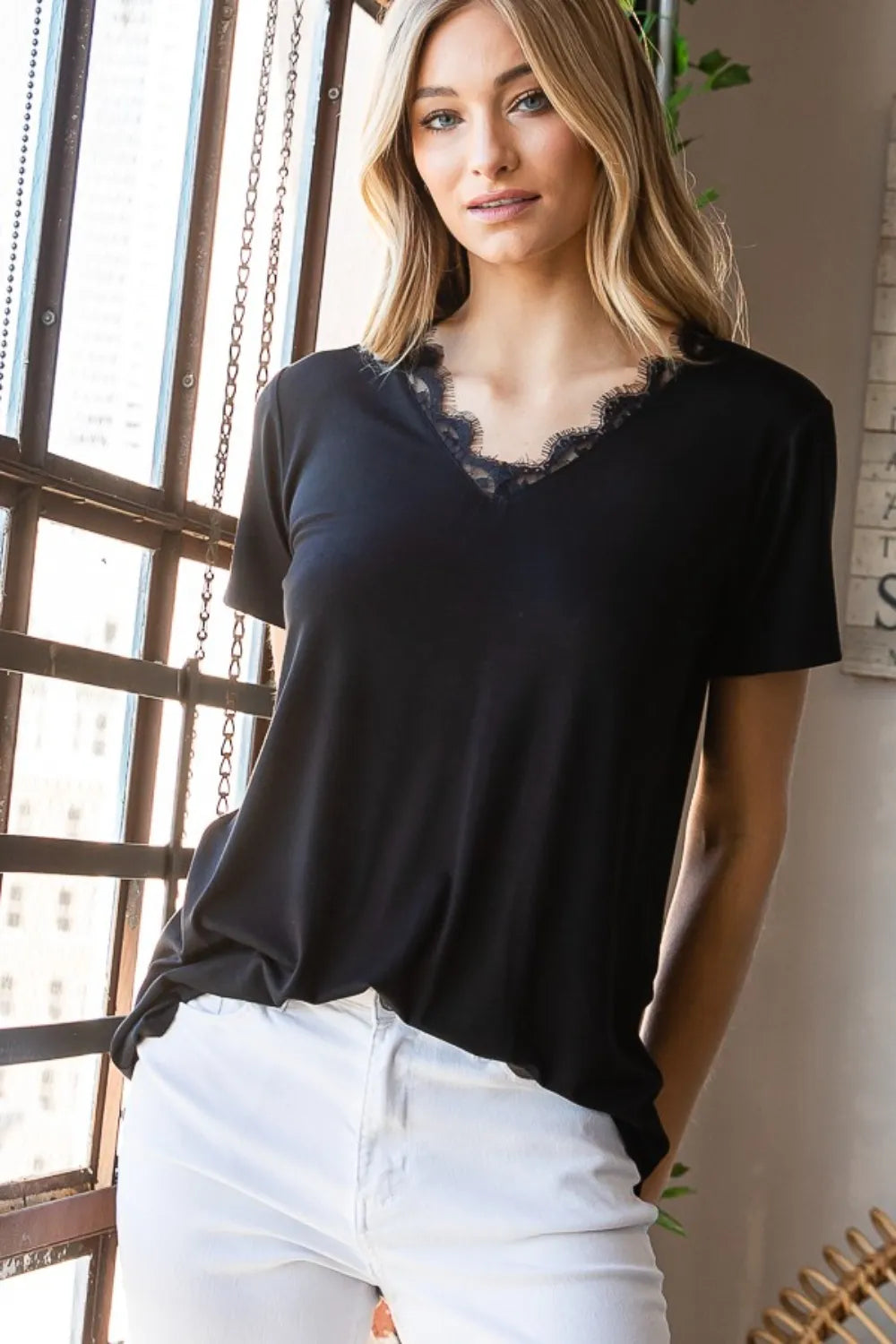 Heimish Lace Detail V-Neck Short Sleeve T-Shirt by Trendsi, featuring a soft fabric and delicate lace accents at the neckline.