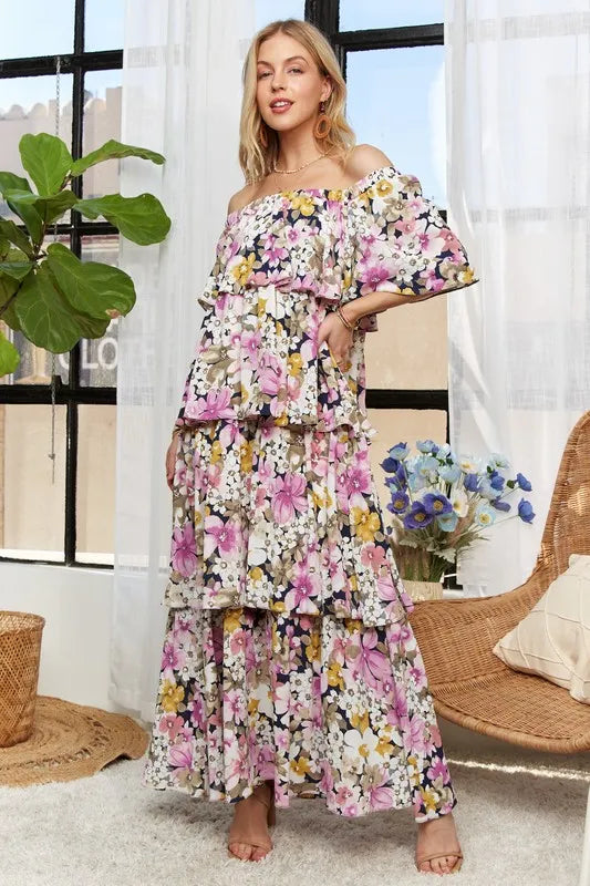 Adora layered floral mauve off-shoulder short sleeve maxi dress by Trendsi, featuring a flowing silhouette and floral pattern.