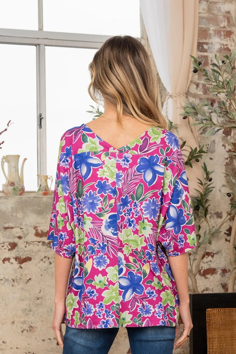 Trendsi Sew In Love floral V-neck half sleeve top in full size, featuring a colorful floral pattern and relaxed fit.