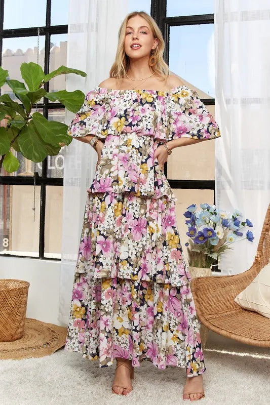 Trendy mauve ADORA layered floral off-shoulder short sleeve maxi dress by Trendsi, featuring a flowy silhouette and floral pattern.