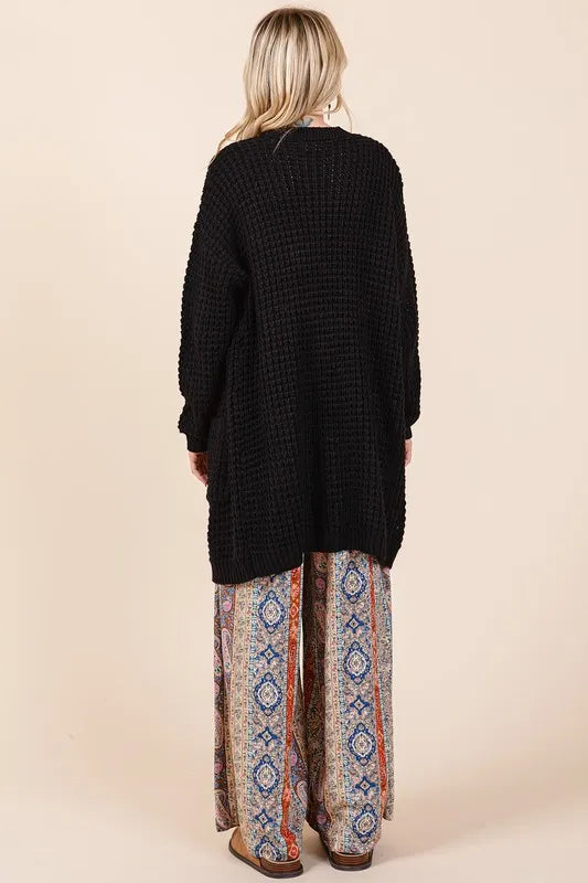 Trendsi Mittoshop open front long sleeve longline cardigan hanging on a hanger, soft knit fabric, casual outerwear for women.