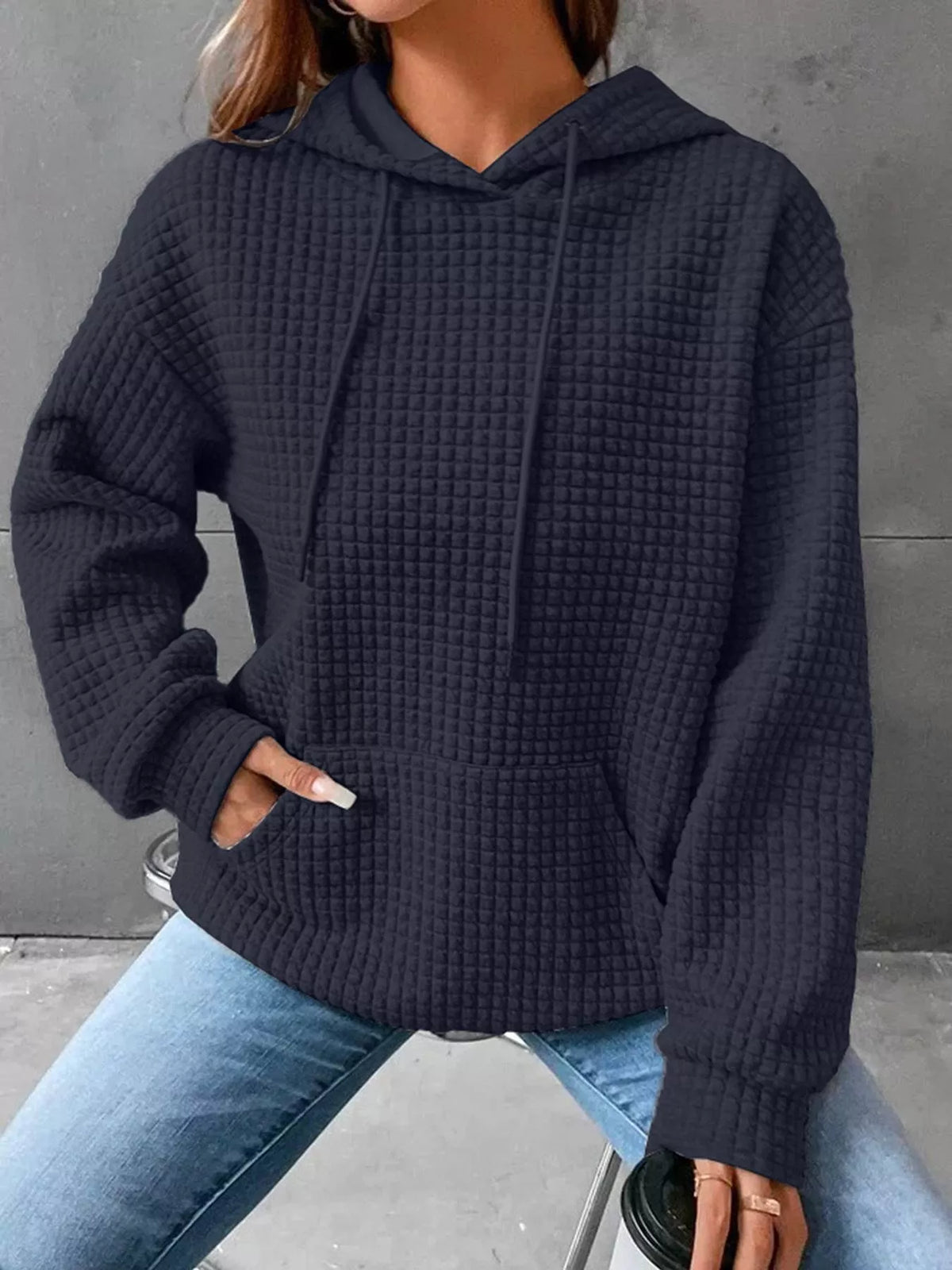 Plus size textured kangaroo pocket hoodie by Trendsi, showing the full front view with a cozy, casual fit and soft fabric texture.