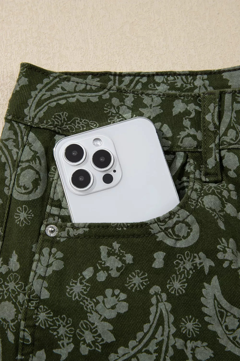 Paisley print harem denim pants by Trendsi featuring relaxed fit and stylish design with intricate paisley patterns.
