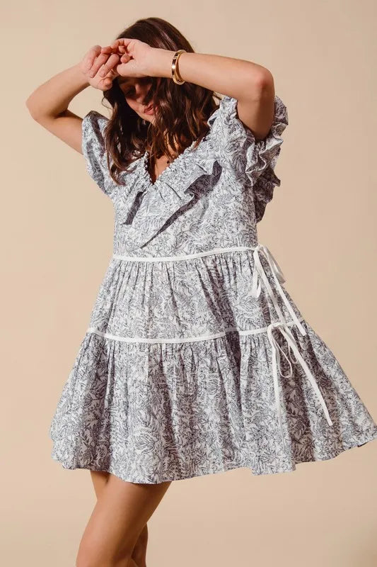 Cotton printed ruffle V-neck dress with side tie detail, stylish and feminine, from Trendsi.