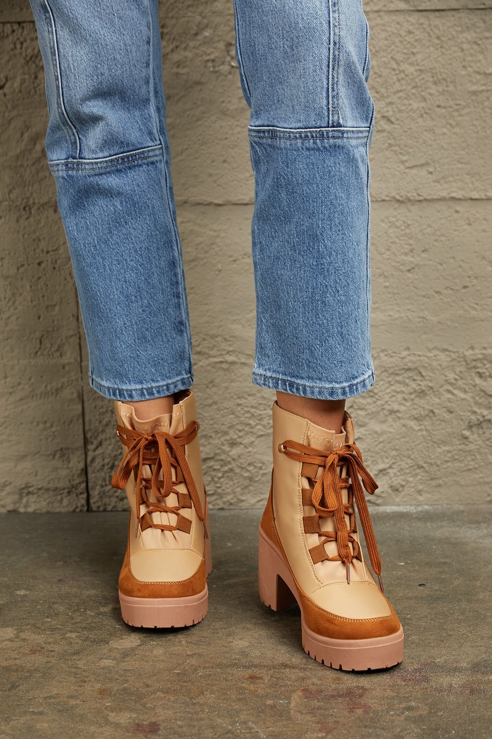 East Lion Corp lace-up lug booties with chunky soles, black leather finish, and stylish design perfect for casual and outdoor wear.