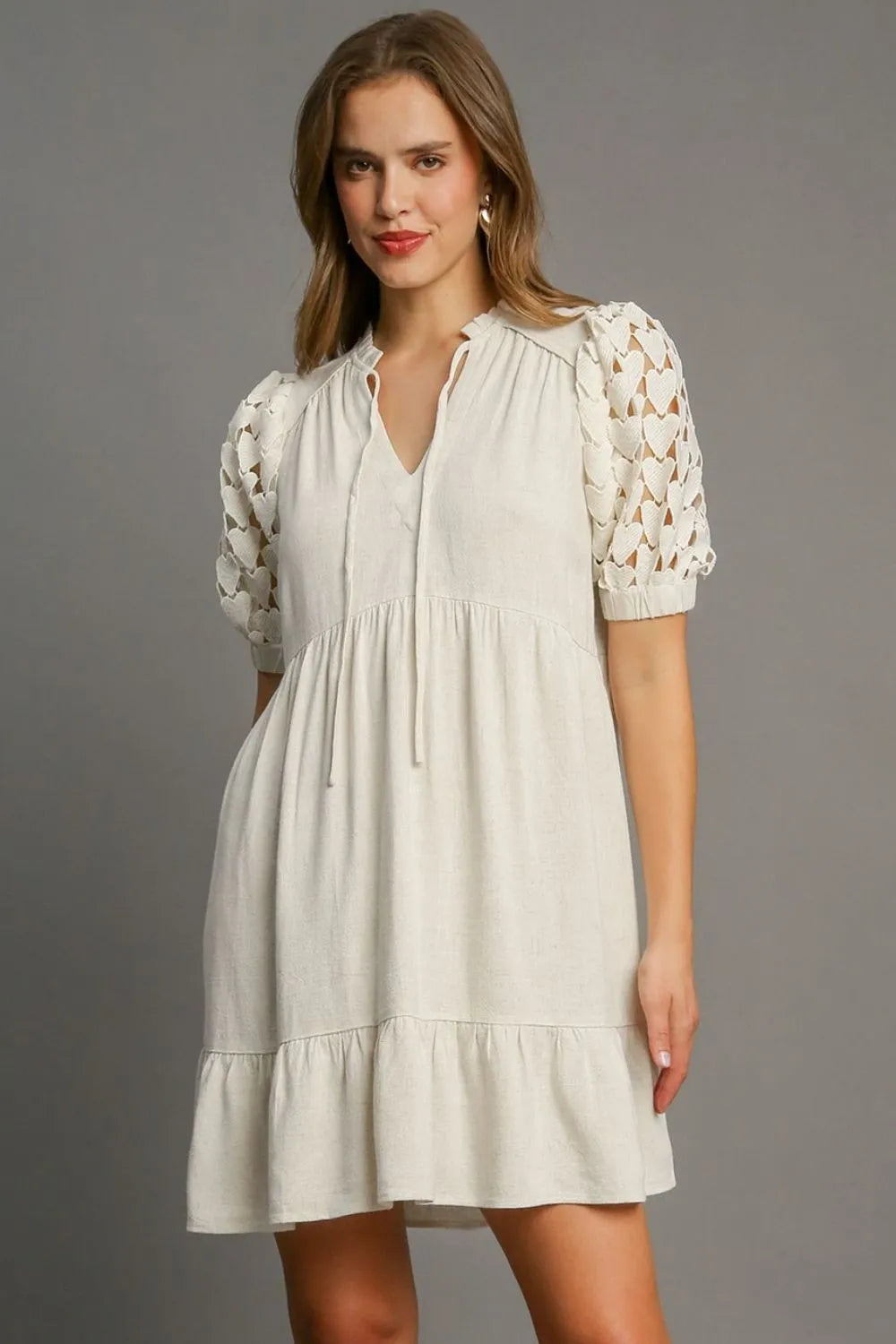 Plus size Umgee lace sleeve tie neck dress with ruffled hem and heart pattern, featuring a feminine, flowy silhouette.