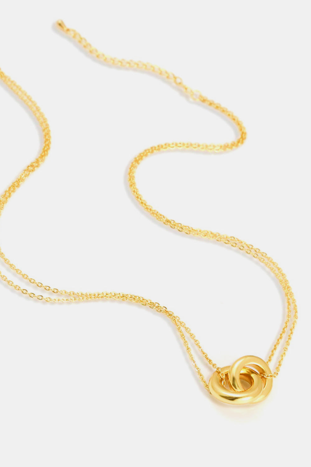 Linked ring pendant chain necklace by Trendsi featuring a sleek metal chain with a circular linked pendant.