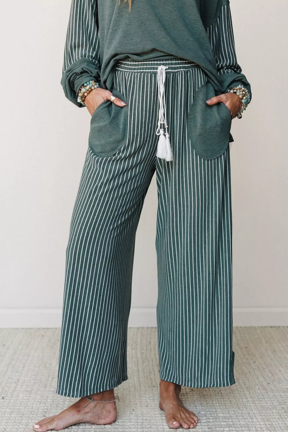 Raw seam patchwork long sleeve top and casual pocket pants set by Trendsi, with a stylish patchwork design and relaxed fit.